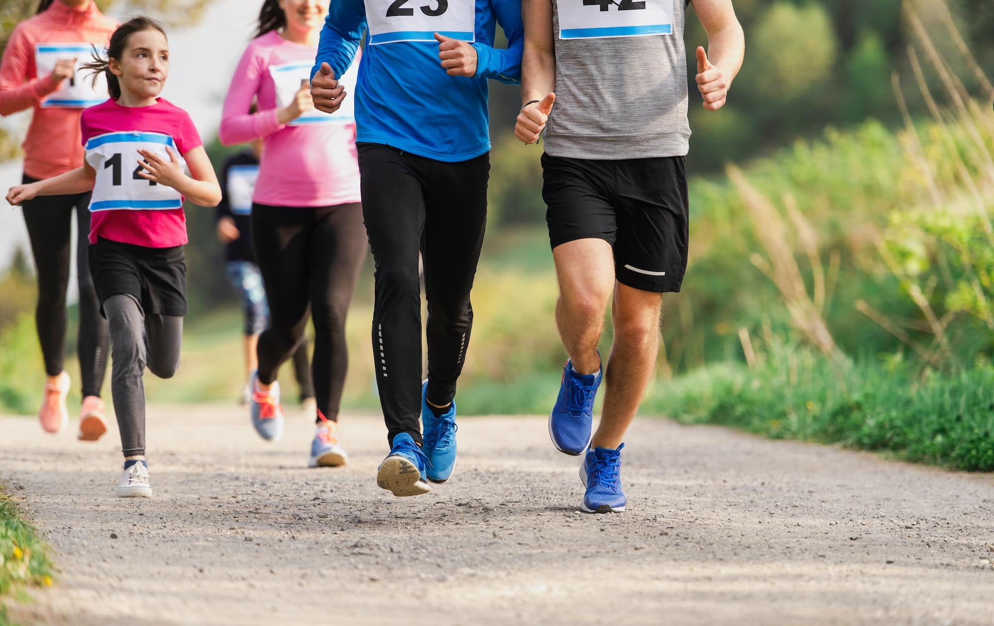 midsection-of-large-group-of-people-running-a-race-competition-in-nature.jpg